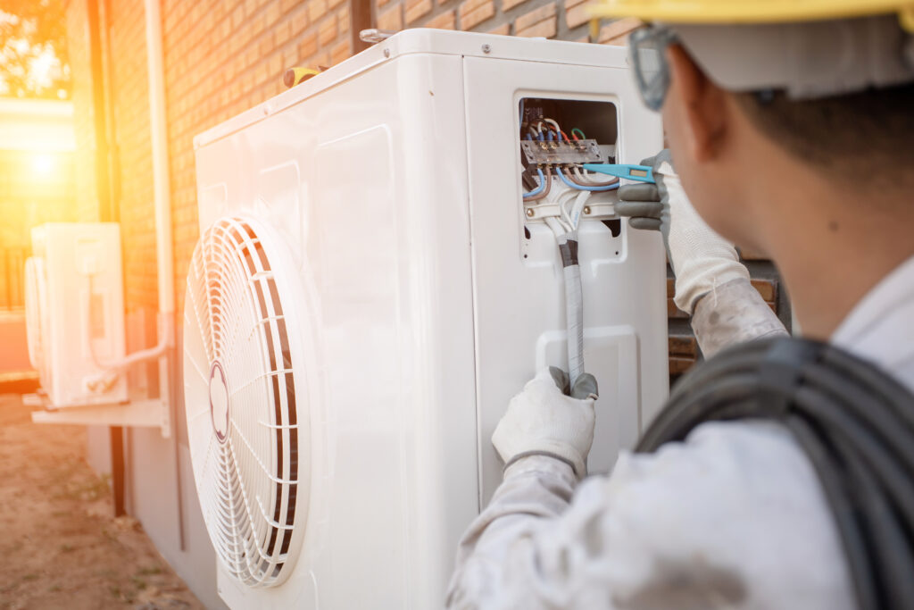Air Conditioning Technician and A part of preparing to install new air conditioner. Technician vacuum pump evacuates and checking new air conditioner